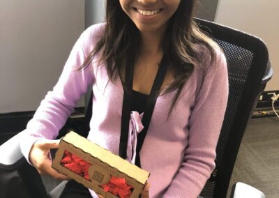 Surtech employee smiling with a Valentine's Day gift from the company.